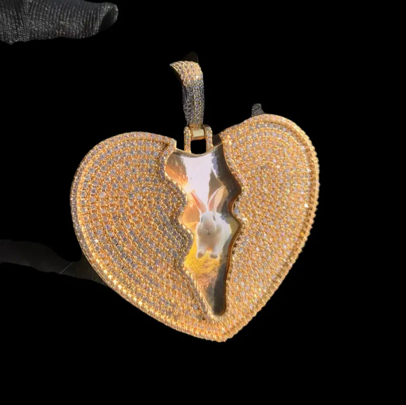Side angle view of iced out custom cracked love pendant