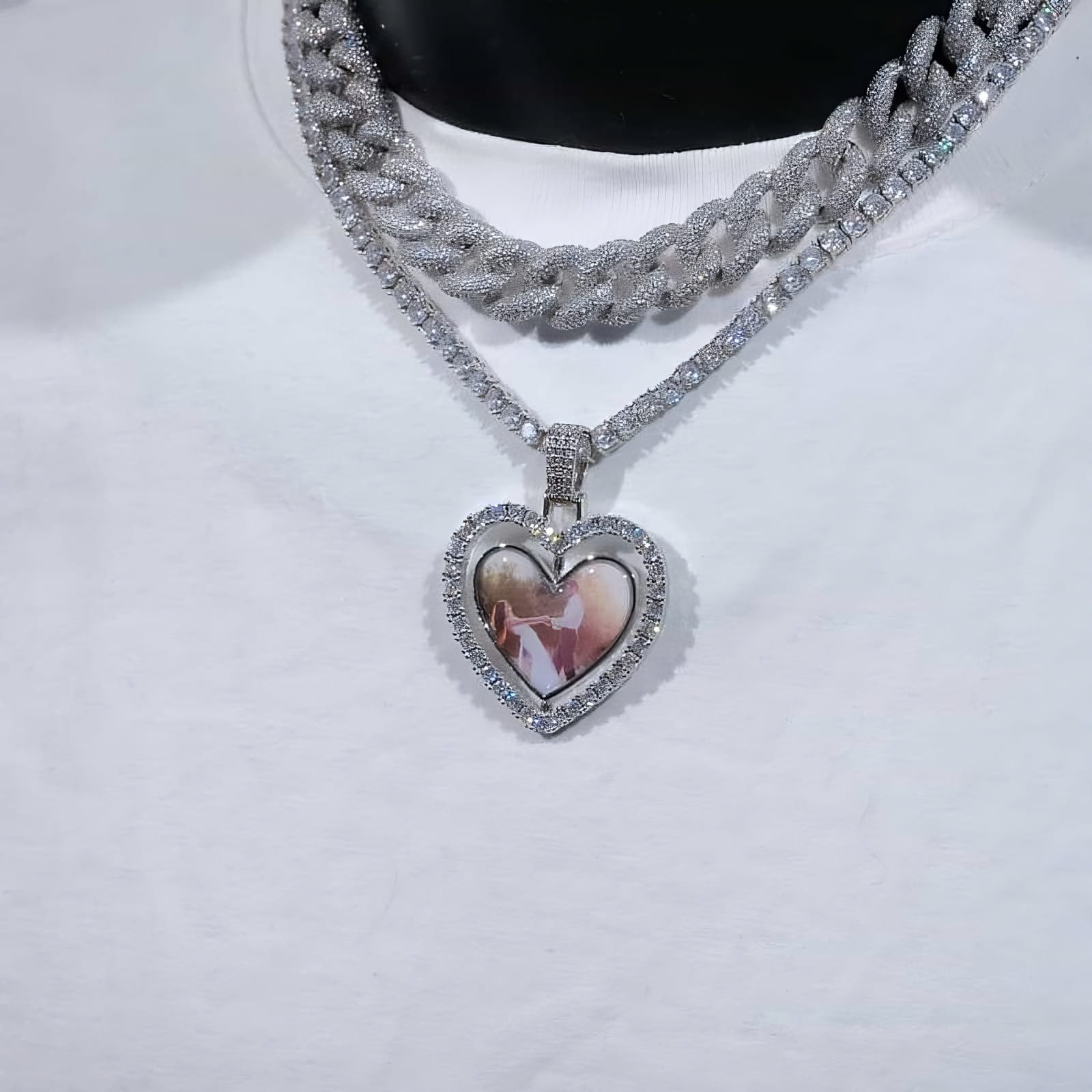 Silver spinning heart pendant with dual photo sides shown on model