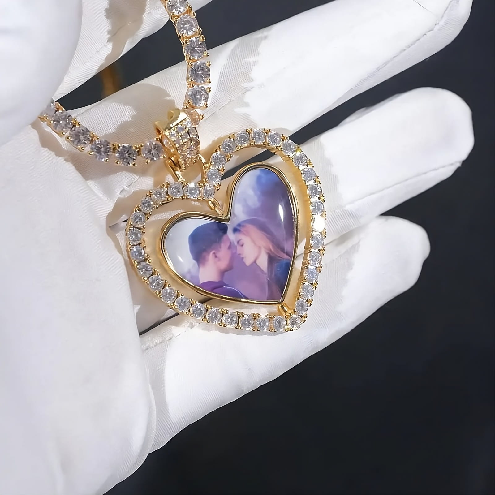 3D heart photo pendant with rotating design held in gloved hand