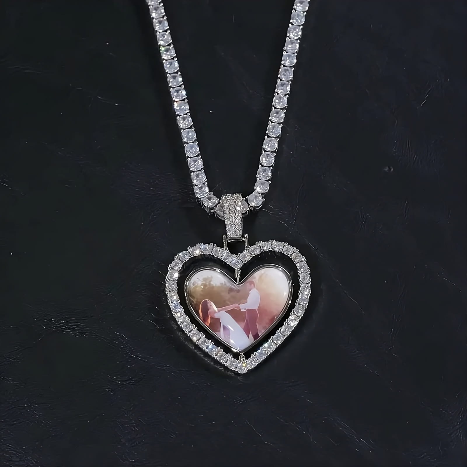 Close-up of custom two-sided spinning heart picture pendant in white gold