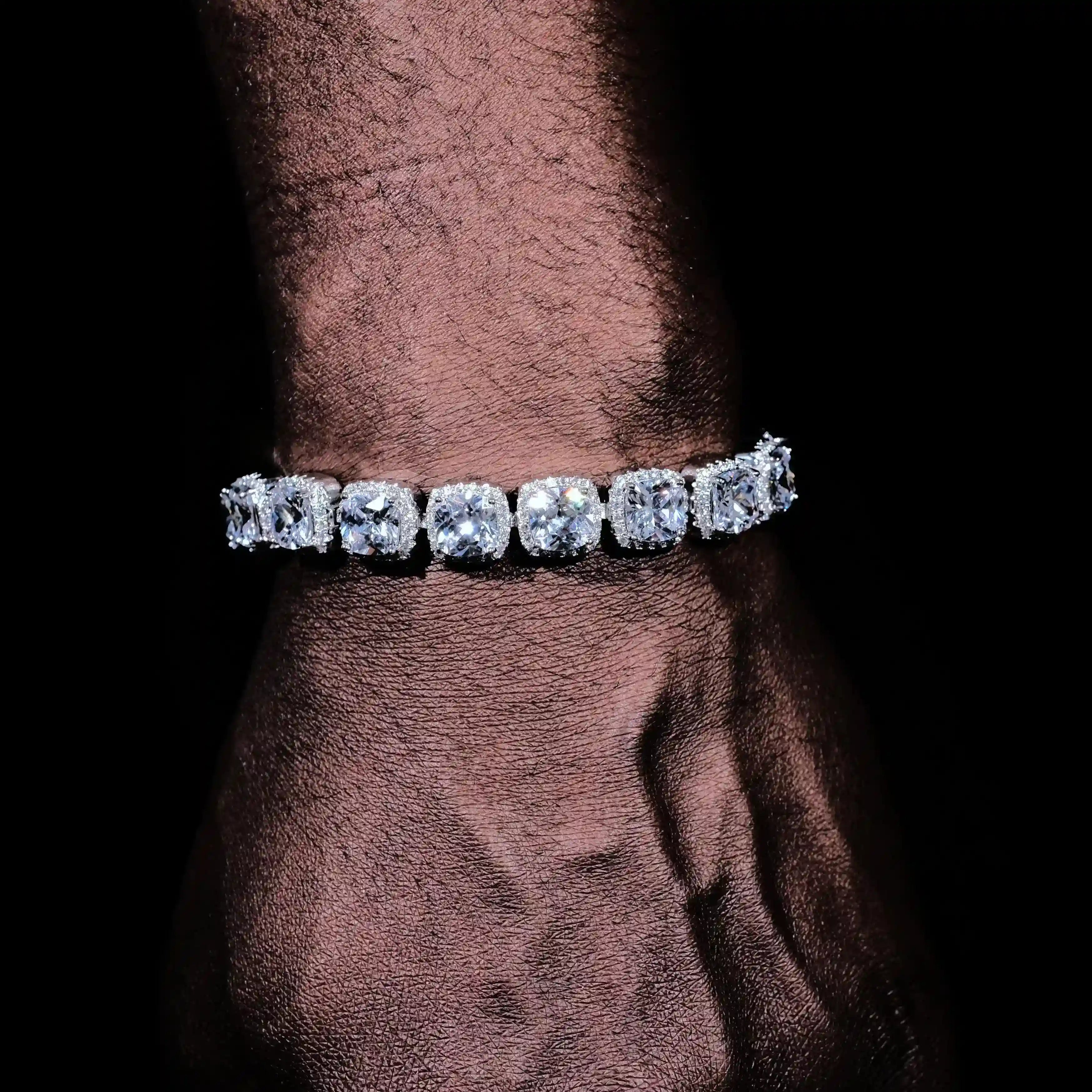 Man wearing Glacier clustered tennis bracelet in white gold with large round diamonds
