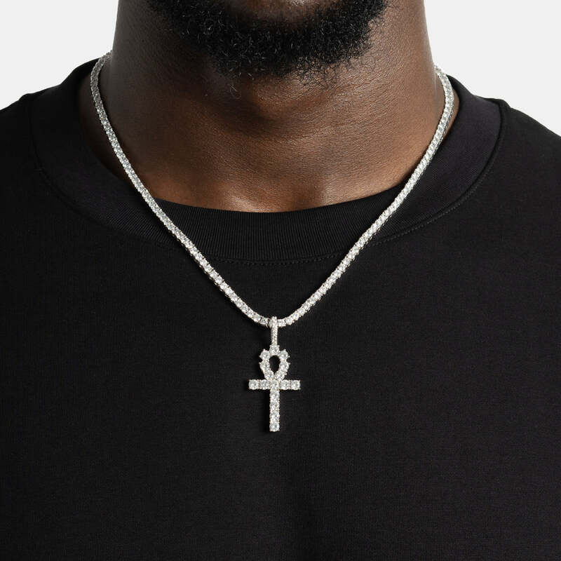 Close-up of iced key pendant necklace in white gold on model’s neck