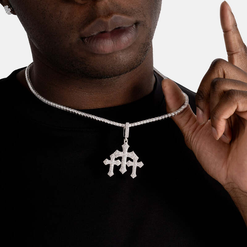 Close-up of triple faithful cross pendant in white gold on model’s neck