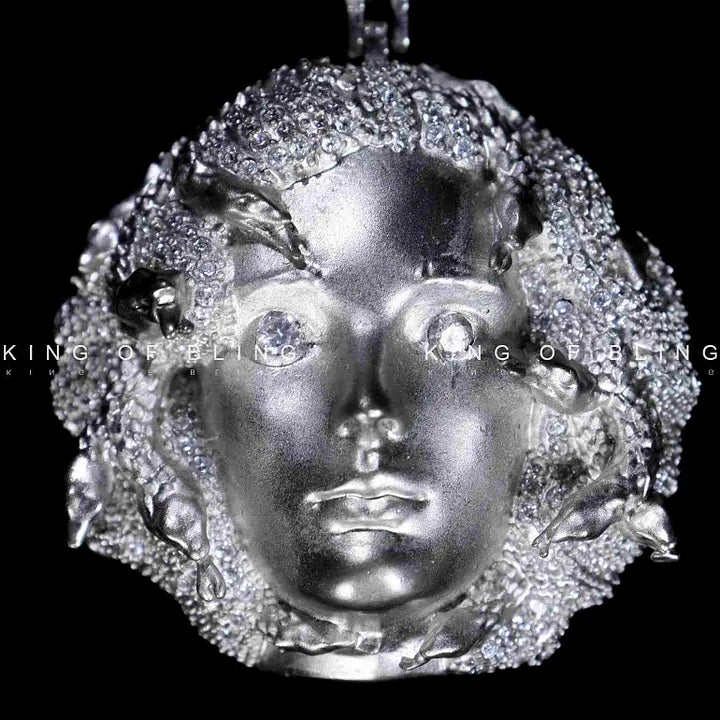 Close-up of Queen Tussauds face pendant showing diamond details and shine