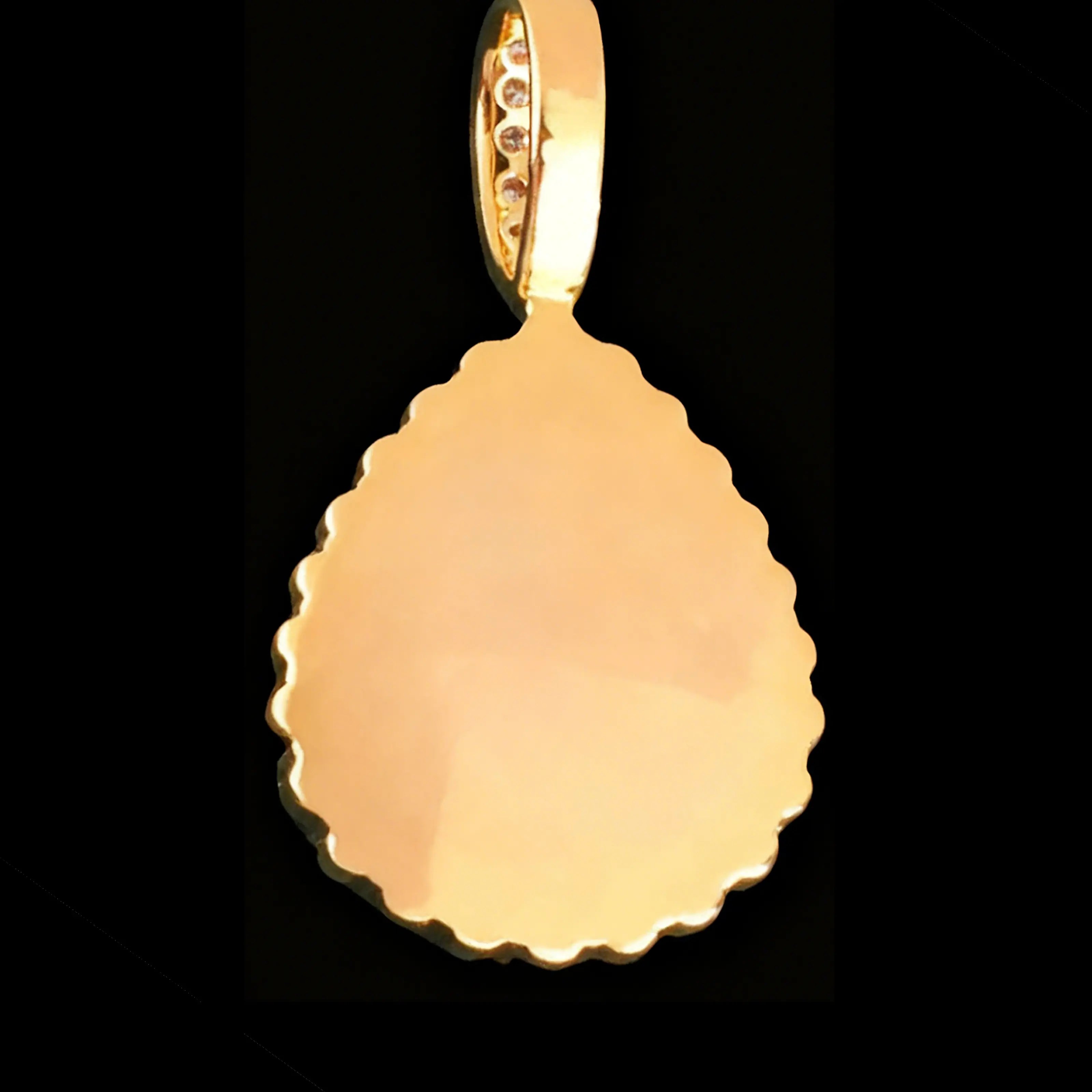 Reverse side of gold teardrop pendant showing plain back design
