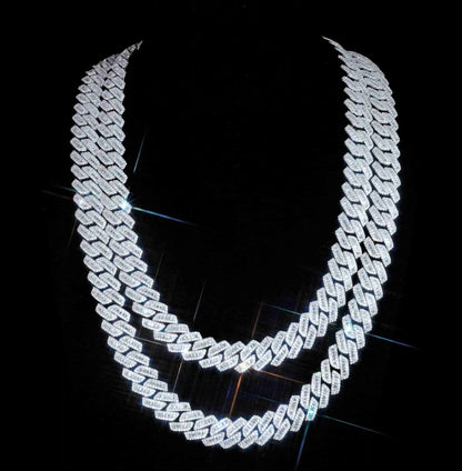 Upgrade your style with our new 13mm curved prong Cuban chain, featuring hand-set baguette stones for a bold and flawless look. Available in multiple lengths and crafted with VVS simulated diamonds, our chain is perfect for any occasion. Package includes chain, dust bag, gift box, jewelry cloth, and warranty card.