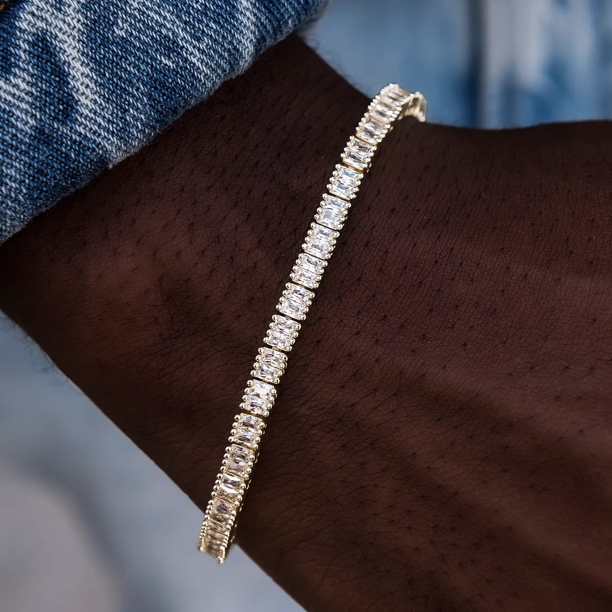 Diamond baguette tennis bracelet in yellow gold 3mm close-up on wrist