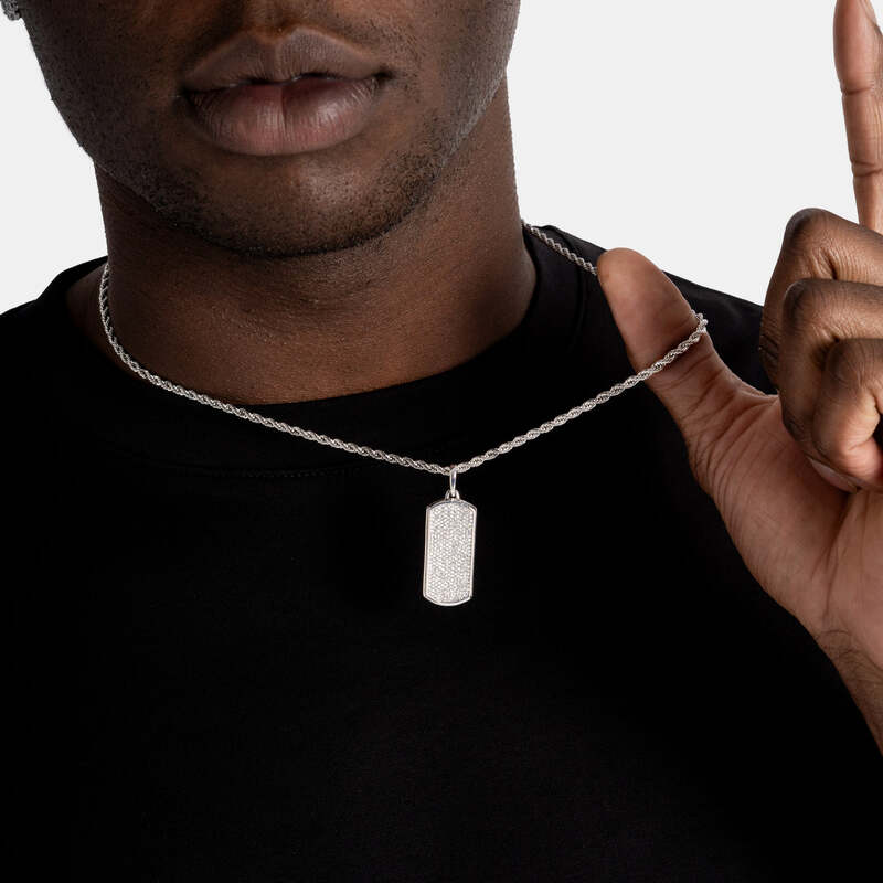 Man holding iced dog tag pendant hip hop jewelry
