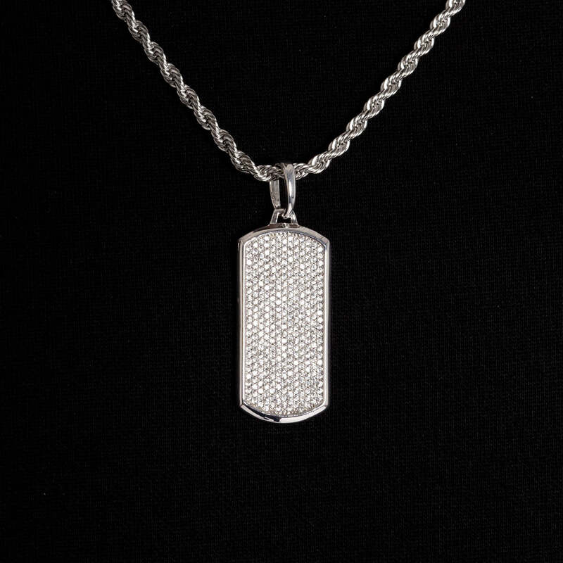 Close-up iced dog tag pendant with diamonds in white gold
