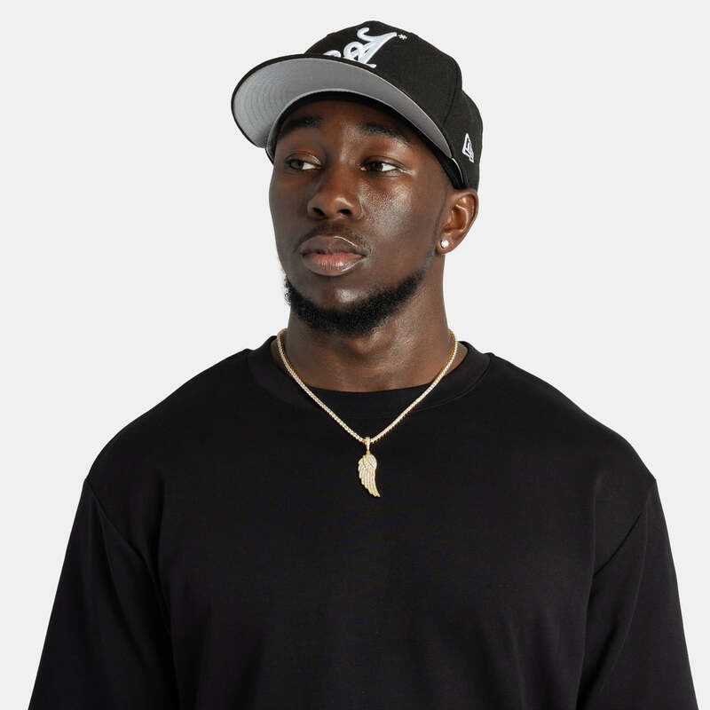 Man wearing iced wing pendant necklace in yellow gold