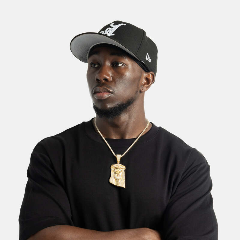 Yellow gold iced cross pendant featuring baguette stones, hip hop jewelry