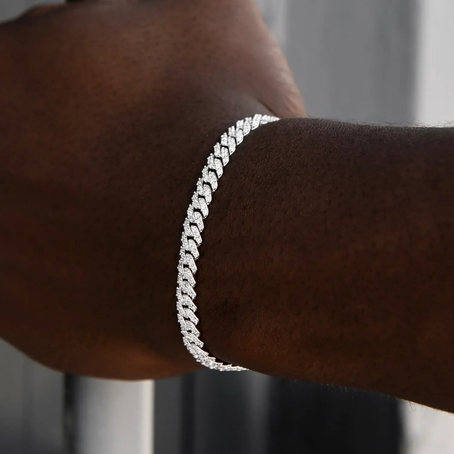 Close-up of 6mm micro diamond prong Cuban bracelet in white gold on wrist