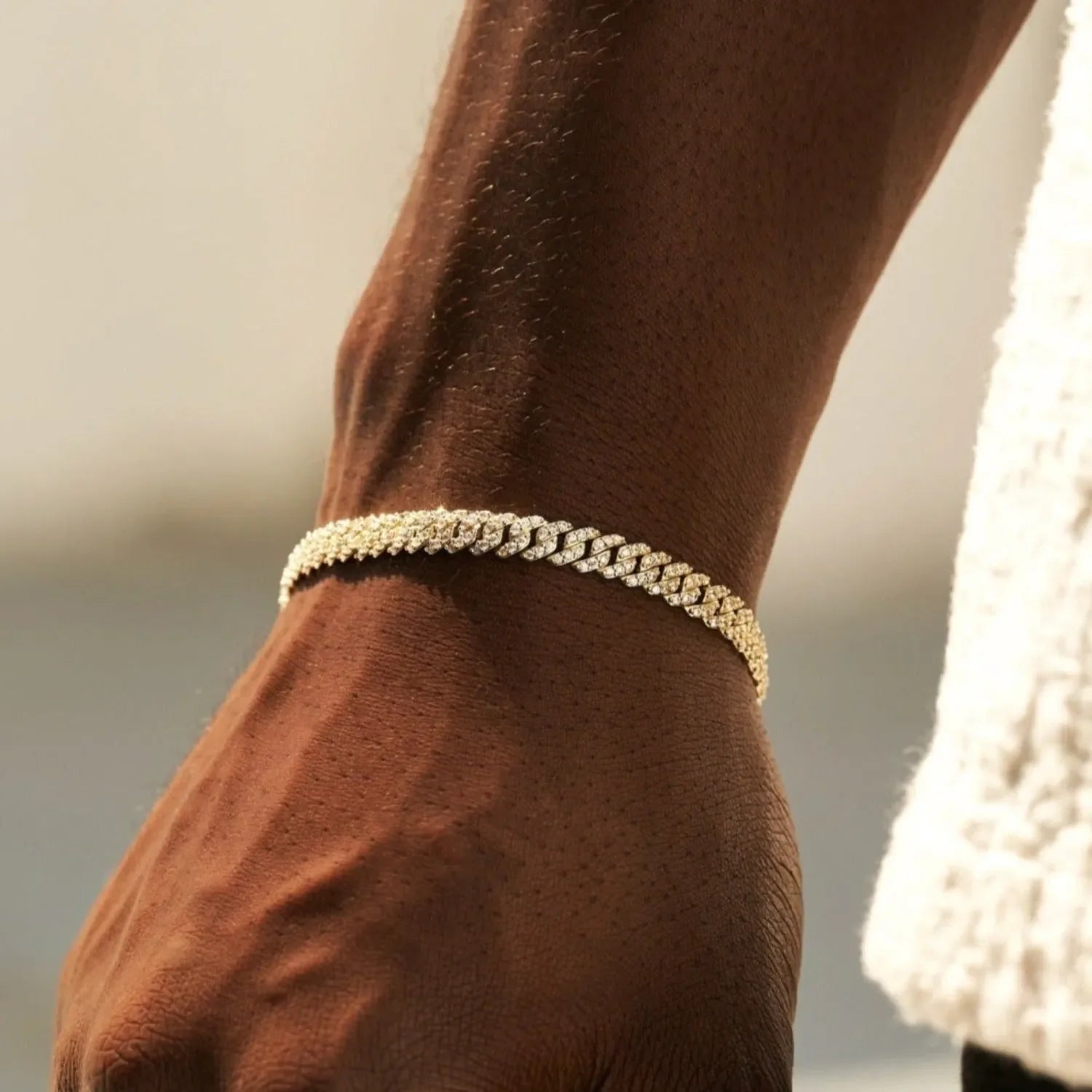 Close-up of 6mm micro diamond prong Cuban bracelet in yellow gold on wrist