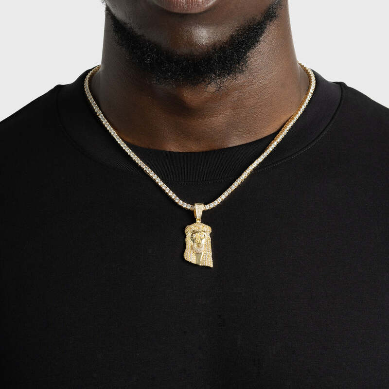Close-up of mini Jesus pendant in white gold on model’s neck