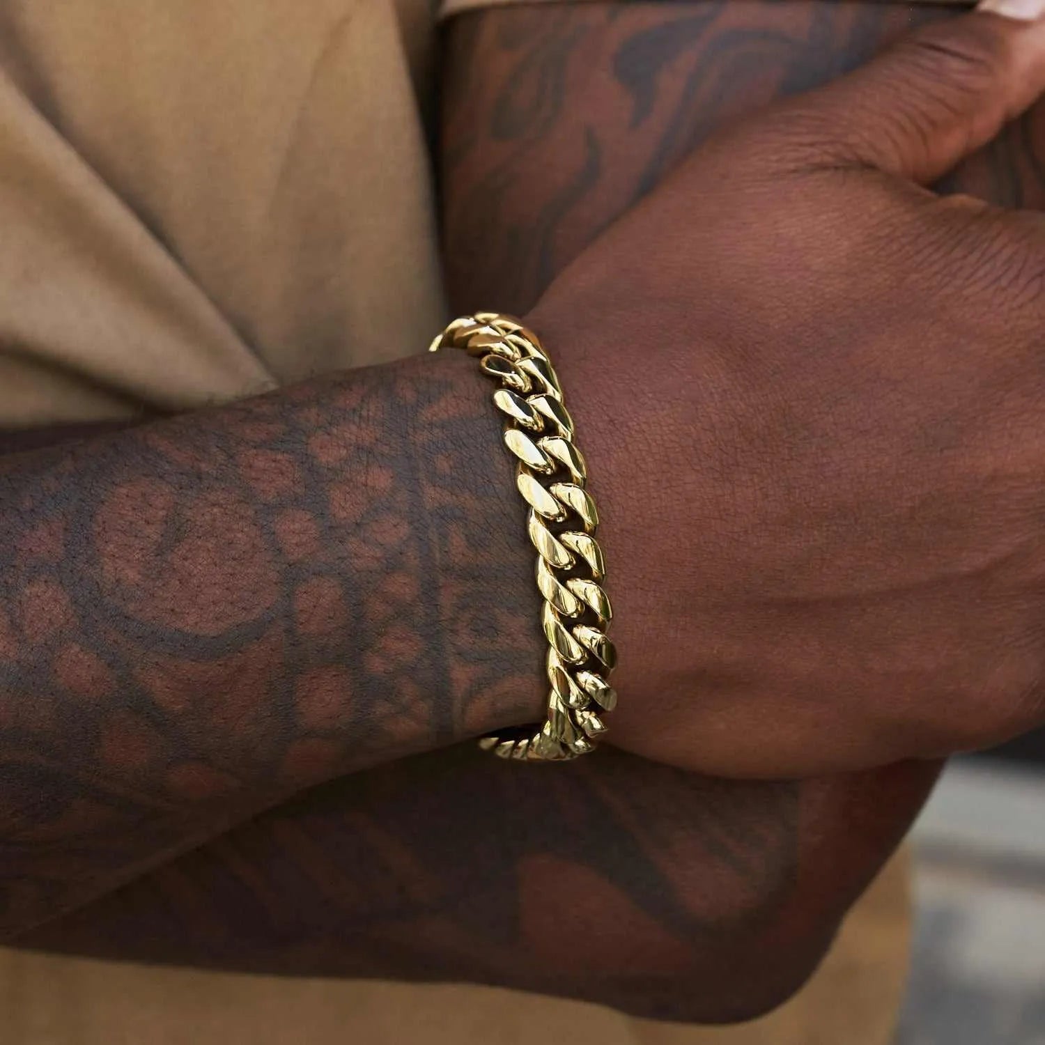 12mm signature Cuban link bracelet in yellow gold on wrist
