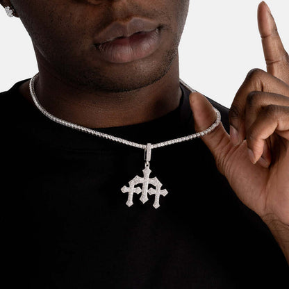 Close-up of triple faithful cross pendant in white gold on model’s neck